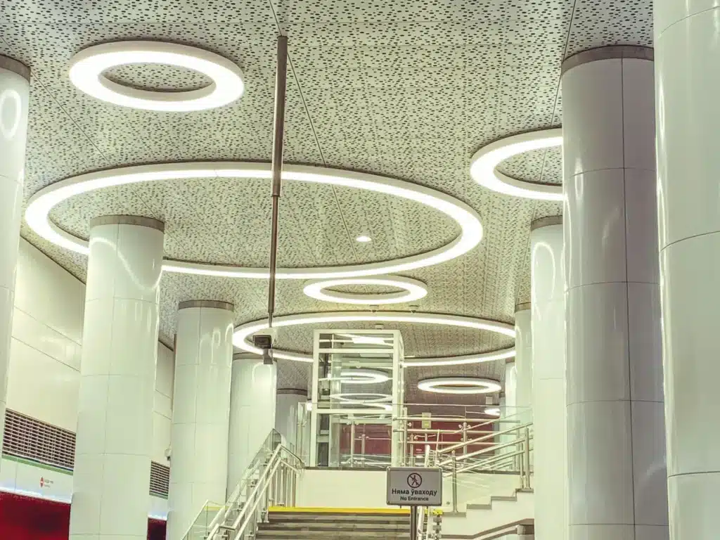 Circular ceiling lights above an interior stairway